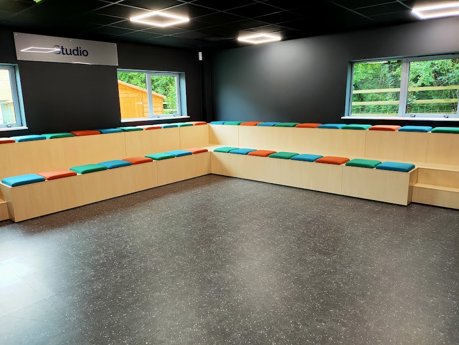 At the end of the room there is tiered seating. This is the area where the session takes place. 